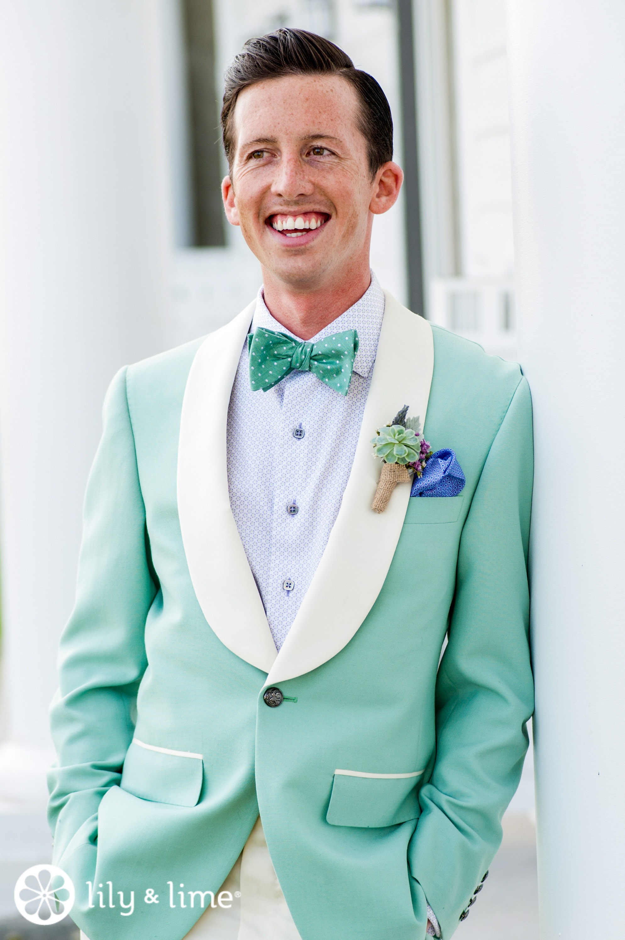 Handsome hipster groom wedding suit with straw hate and tropical