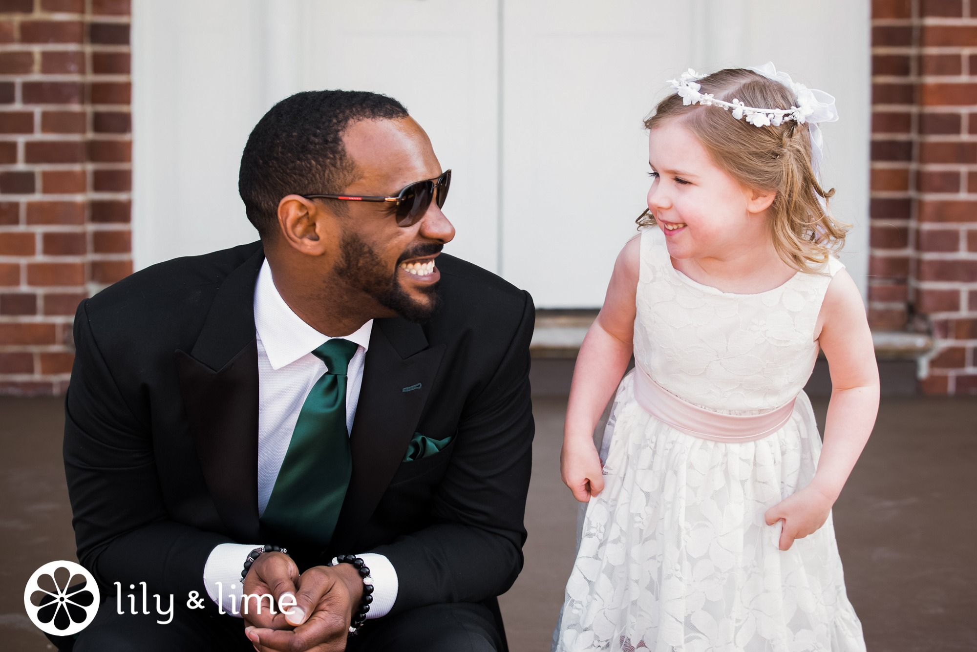 candid groom and flower girl