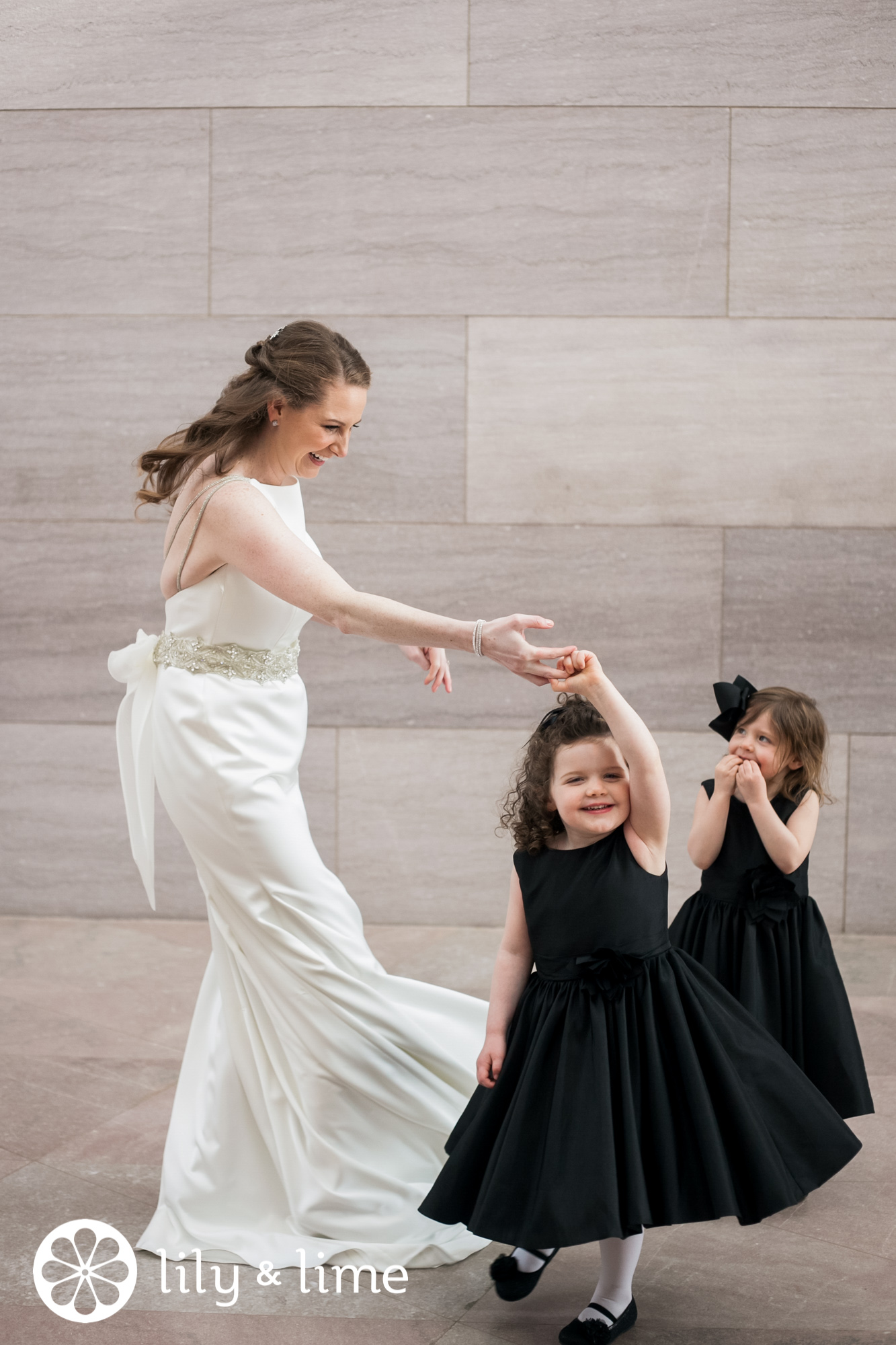 bride candidly twirling flower girls