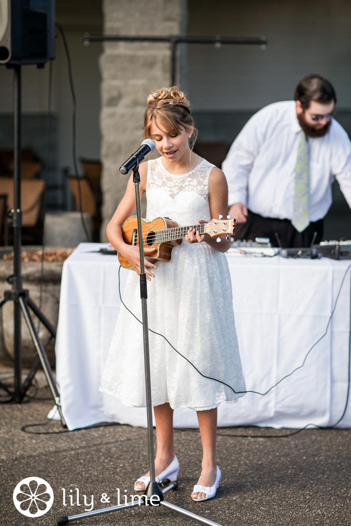 flower girl singing with guitar wedding reception