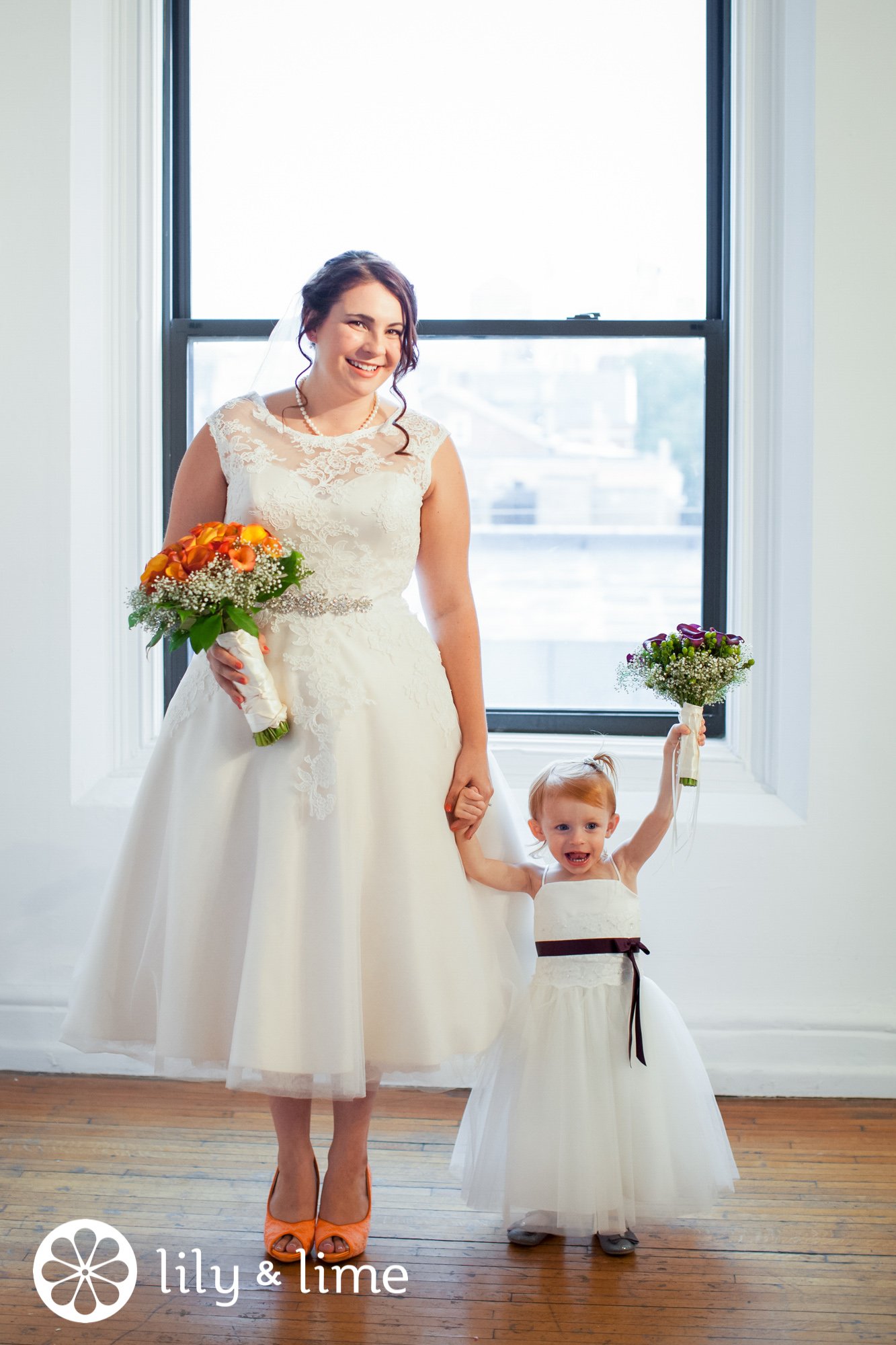 bride holding hands with flower girl